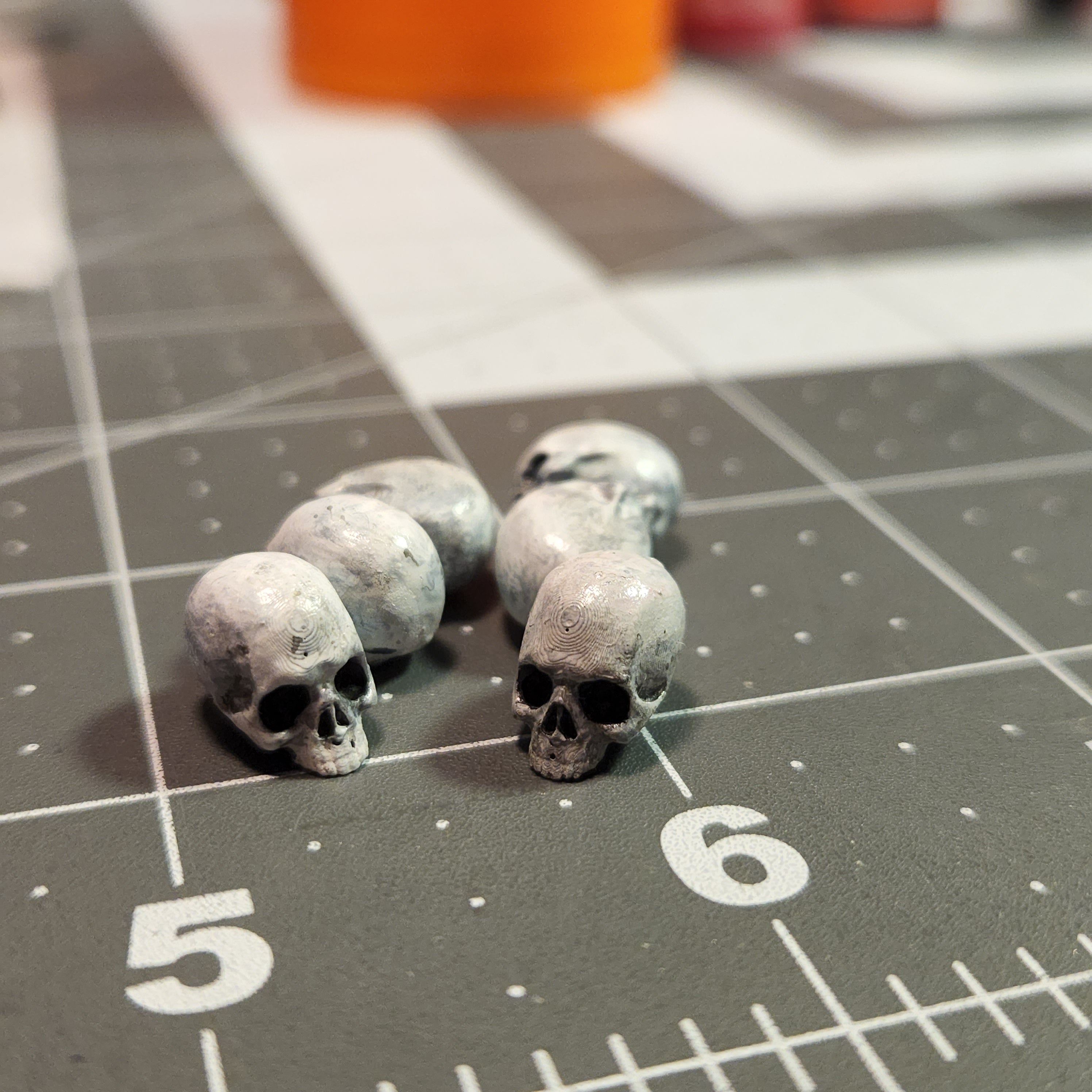 3D Printed mini skulls for inclusions in dice. Painted to look like skulls