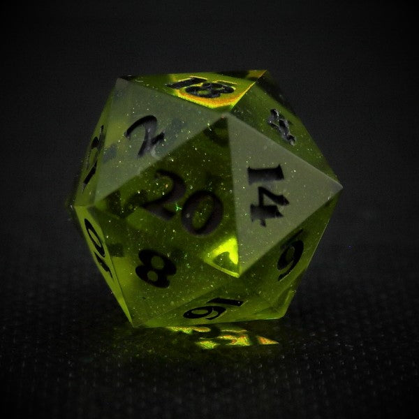 Glittery green spherecore D20 with a shadow shell. Inked in silver.