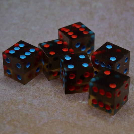 6 pip translucent black D6 set of dice inked in an alternating opposite red and blue pattern.